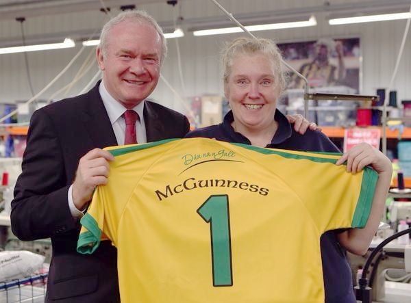 Martin McGuinness stitching a Donegal jersey together, under the supervision of Kieran Kennedy, managing director, and staff member Josie Friel,from Lifford, during his visit to O'Neill's in Strabane. Photo: Lorcan Doherty Photography 