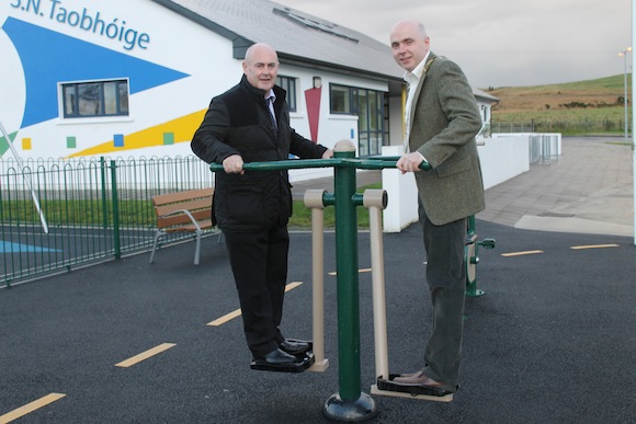 Cllr Patrick Mc Gowan and chairman of Donegal County Council John Campbell  try out the Adult Exercise Machine at Glenfinn Play area.