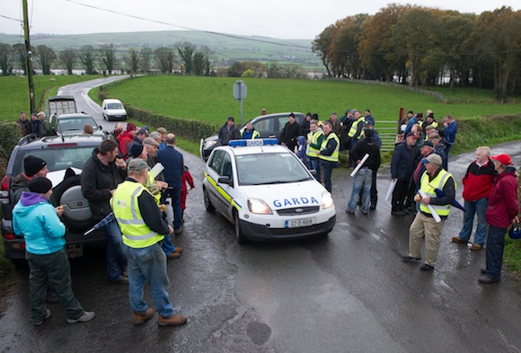 Garda checking out the protest by members of Donegal IFA as they blockade the Donegal / Foyle Meat's Factory Carrigans as part of there nationwide protest at the low prices being paid for cattle. Photo- Clive Wasson