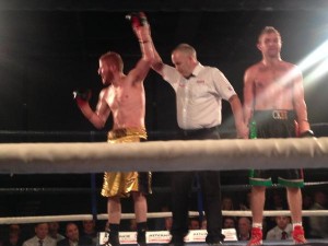 The referee raises the hand of Brad Botham as a disgusted Shaun Mc Shane looks on. 