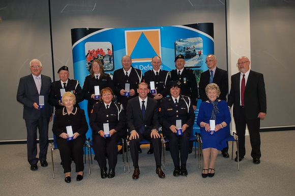   Photo caption: Back Row, L-R, Mr. Joe Breslin, Mountcharles (30yrs), Mr. James Dolan, Stranorlar (40yrs), Ms. Anne Marie Monagle, Glengad (30yrs), Mr. Hugo Boyle, Carrigart (30yrs), Mr. Denis Gallagher, Burt (30yrs), Mr. John Quinn, Ballybofey (30yrs), Mr. Brian Spain, Director for Civil Defence, Dept of Defence, Mr. Bill Smith, Director General, Civil Defence, Roscrea Front Row, Ms. Rose Mc Namee, Letterkenny (40yrs), Ms. Jackie Mc Crudden, Burt (30yrs) Mr. Paul Kehoe, The Minister for State at the Department of Defence, TD, Ms Edel Flynn, Ballybofey, Civil Defence Officer (30yrs), Ms. Ita Wilkie, Letterkenny (30yrs)  