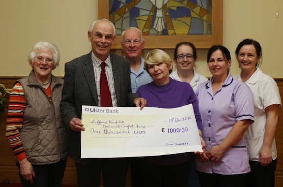 John presents the cheque which were the proceeds form his 80th birthday. Pic by North West Newspix.