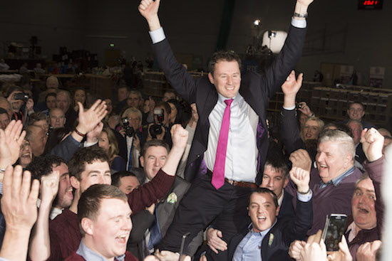 A jubilliant Charlie McConalogue is raised by supporters after he reclaimed his seat in Donegal. (North West Newspix)