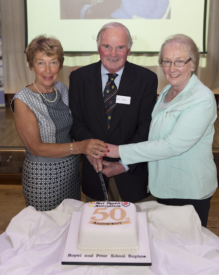 Founding members John Carlin, cut the cake at the Royal & Prior School Past Pupils Association 50th anniversary reunion.