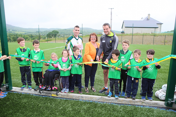 Michael Murphy cuts the tape at the opening of the new pitch  with Michael Quinn Chairperson of the Parents Committee pictured with student and  principal Joseph Gallanagh. David Mc Daid