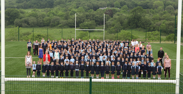 Children and teaching staff at Glenswilly pictured as they get a look at their new football pitch before it was officially opened by Michael Murphy. Photo Brian McDaid/Cristeph