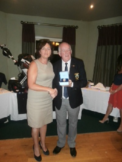 Sandra Mc Monagle receiving the winning ladies prize from Capt Ivan Furey on his Captains night