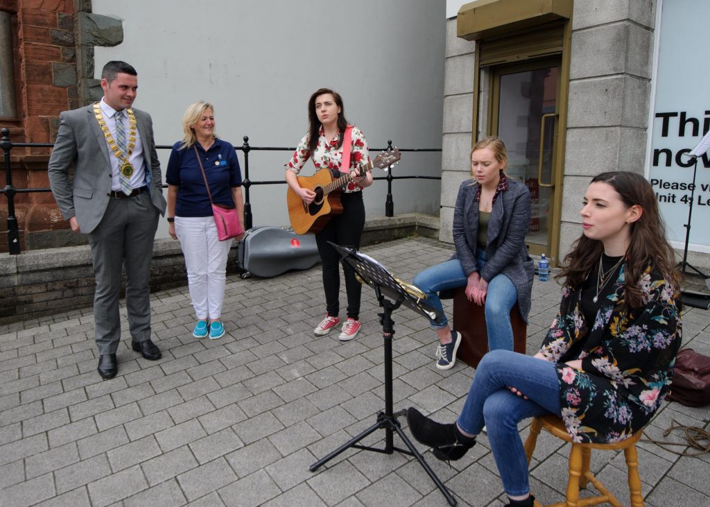 Letterkenny Mayor, John Pat McDaid and Toni Forrrester, CEO Letterkenny Chamber watching 3Libretto taking part in the Letterkenny Chamber Shop LK busking Competition in Letterkenny on Saturday last.  Photo Clive Wasson