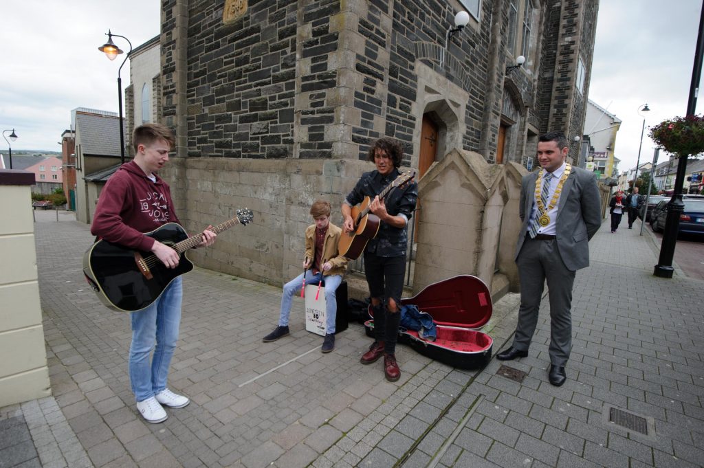 John Pat McDaid watching Nineteen 80 Something , DAvid Doherty, Emett O'Neill and Jamie Boner taking part in the Letterkenny Chamber Shop LK busking Competition in Letterkenny on Saturday last.  Photo Clive Wasson