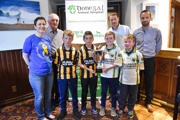 Childhood Cancer Foundation's Maura Toner, CLG Bord Inis Eogahn's Gerard Callaghan, Gerard Roarty of Donegal Animal Hospital who are main sponsors of the event, John Mc Laughlin, treasurer of Inis Eogahn Bord, with representatives from Malin and Glenswilly U11 teams who will compete in the final on Friday 23rd of September at Buncrana.