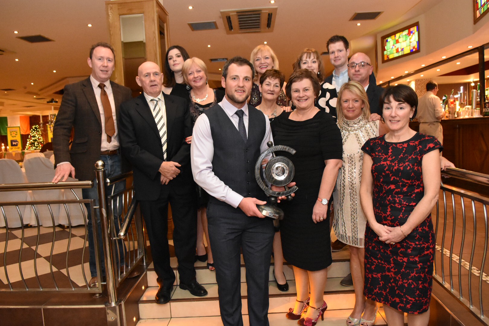 Members of RTÉ RnaG Doirí Beaga staff with Michael Murphy, Dolores Mhic Géidigh and Edel Ní Chuireáin. In this photo Michael holds a clock by Fergal Megannety, part of the presentation of the award for this inaugural year, which he can keep.